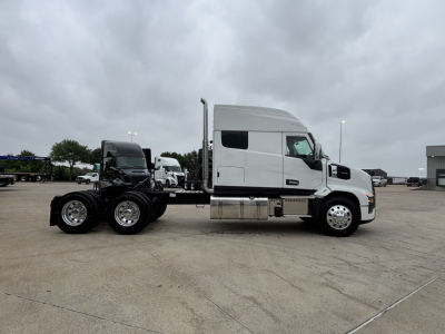 Mack PR64T76M conventional sleeper truck side profile showing cab, chrome exhaust stack, dual rear axles, and fuel tanks.