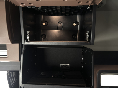 Mack PR64T76M truck cab interior showing storage compartments and dash area with empty overhead bin