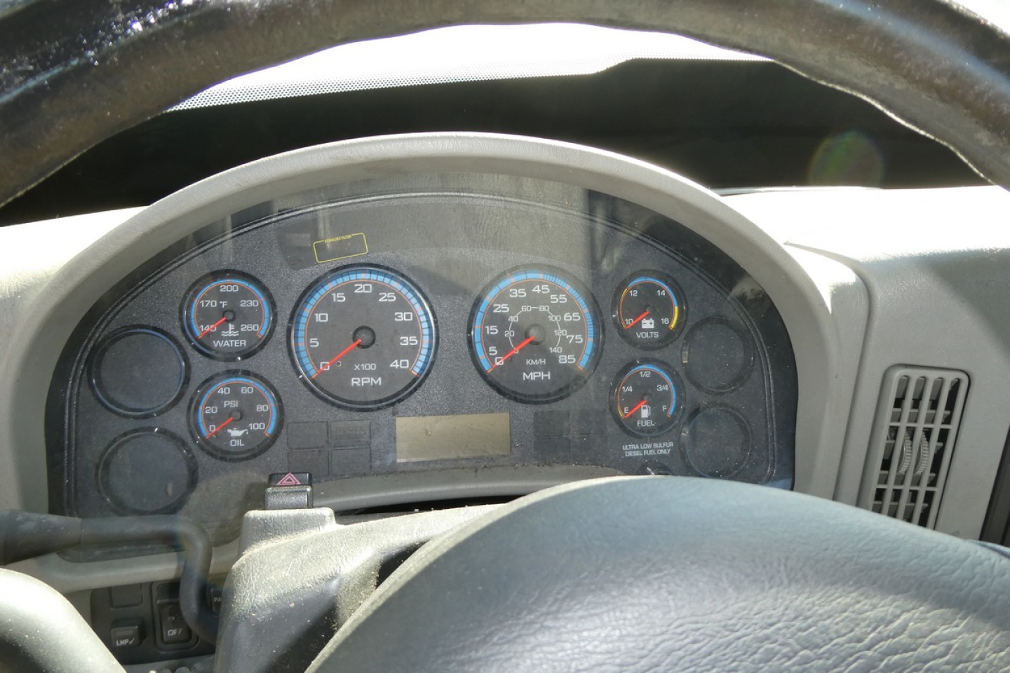 Dashboard view of a 2012 International TERRASTAR cab and chassis showing gauges and steering wheel.