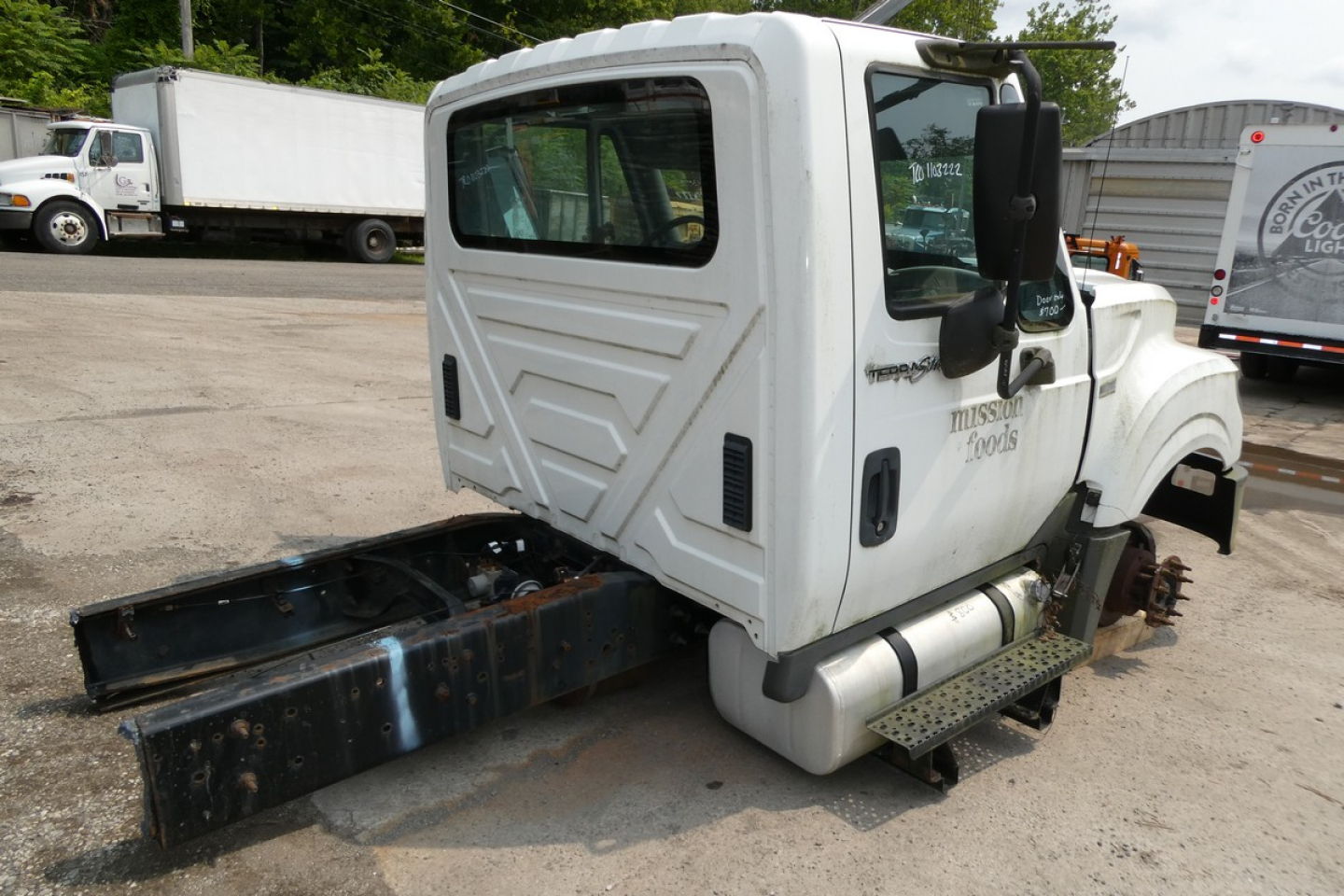 International TERRASTAR cab and chassis showing side view with white cab, black chassis hitch, and steps.