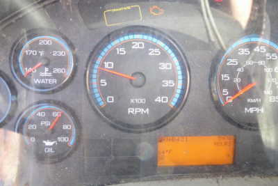 Dashboard cluster of a 2012 International TERRASTAR showing RPM gauge, water temperature, oil pressure, air temperature readout, and an orange digital display.
