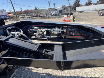 Trailer hydraulic system and frame showing hoses and fittings on a Load King lowboy trailer.