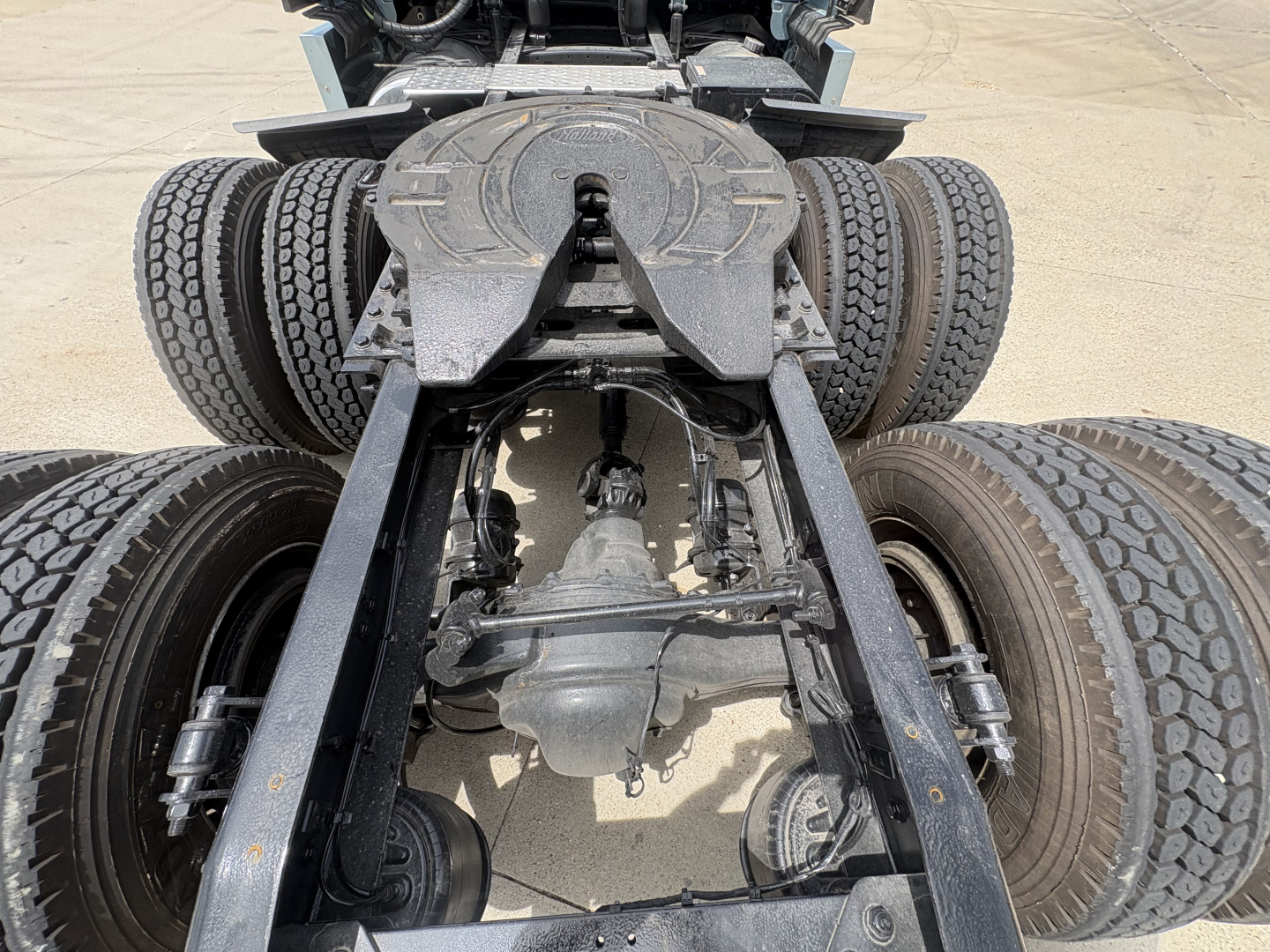 Freightliner Cascadia 126 chassis rear view showing fifth wheel and dual rear axles with suspension components.
