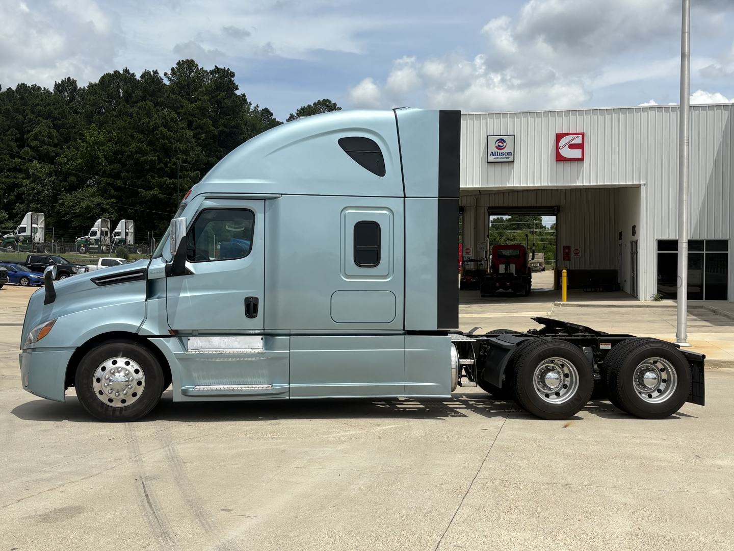 2023 Freightliner Cascadia 126 tractor side profile showing cab with sleeper, dual rear axles, and windows.
