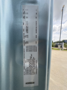 Label on Freightliner truck door with vehicle weights and axle ratings; shows 'Gros Vehicle Weight', 'GAWR', 'Gross Axle Weight Rating' values and various numbers in small print.