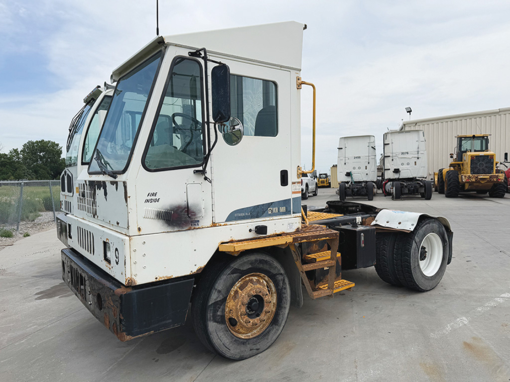 Ottawa Kalmar yard truck tractor showing front cab and chassis with white cab, black bumper, and rust spots.