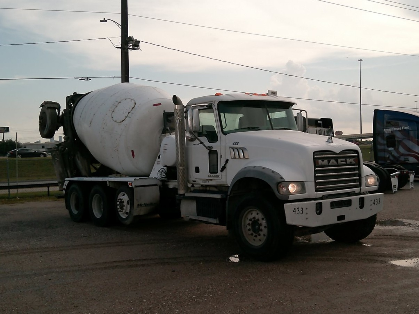Mixer truck with cement mixer on a Mack GU713 chassis, white cab and mixer drum, stock number B3847P, VIN 1M2AX04C9HM031350.
