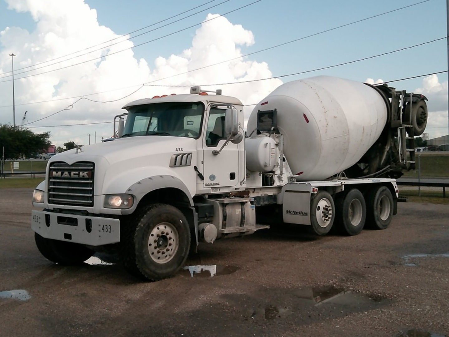 Front left view of a white 2017 Mack GU713 mixer truck with a cement mixer drum. visible text on truck includes Mack emblem on grille; no other legible labels.