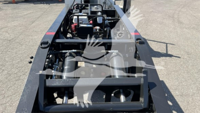 Trailer underside view showing hydraulic components and frames of a Fontaine Renegade Xn20 lowboy trailer.