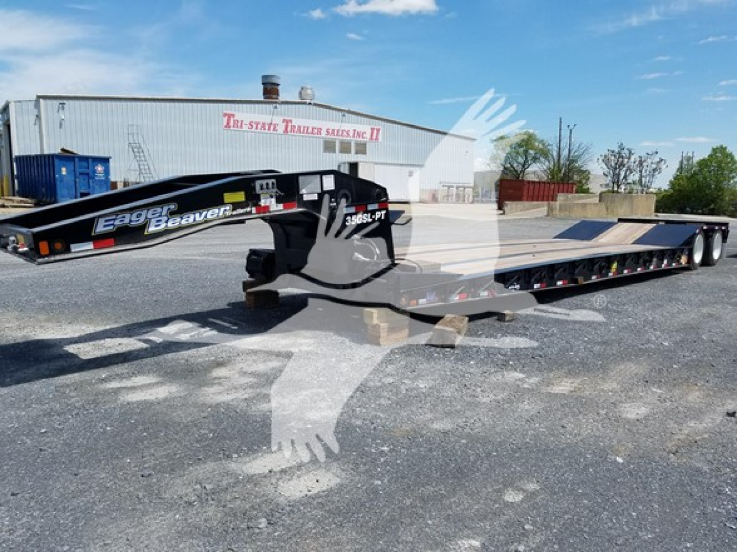 Trailer showing Eager Beaver Gsl-PT lowboy deck and gooseneck with black frame and yellow-green logo, 3-axle configuration, and serial labeling on the side.
