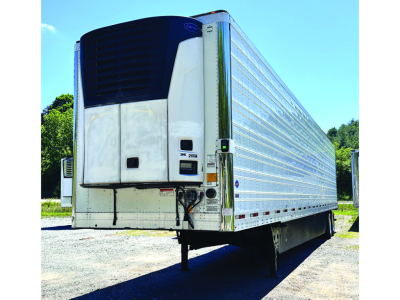 Utility 3000R trailer rear with reefer unit, white sides, blue refrigeration unit, side rails, and landing gear visible.
