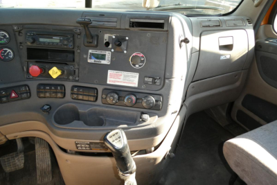 Freightliner Cascadia 125 dash panel showing steering column, gauges, controls, and gear shifter.