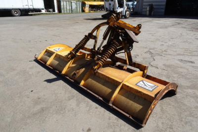 Mack Granite GU712 front-edge implement bucket attachment with hydraulic arms in a yard.