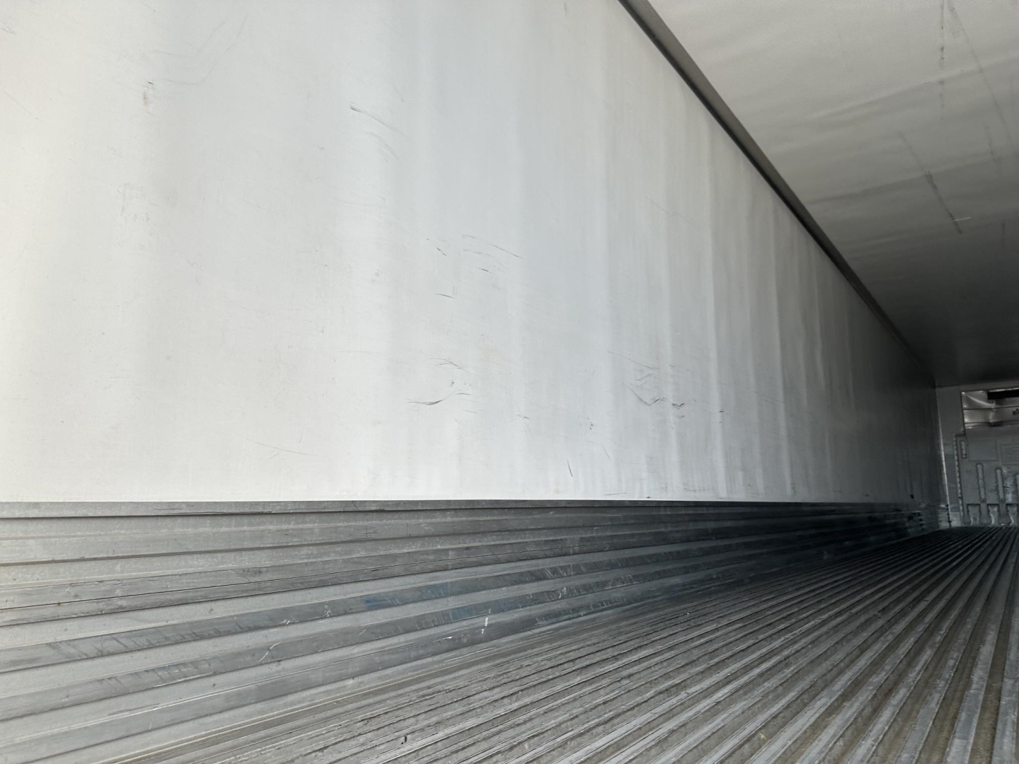 Trailer interior of a 2017 Utility 3000R refrigerated trailer showing ribbed floor and smooth side walls.