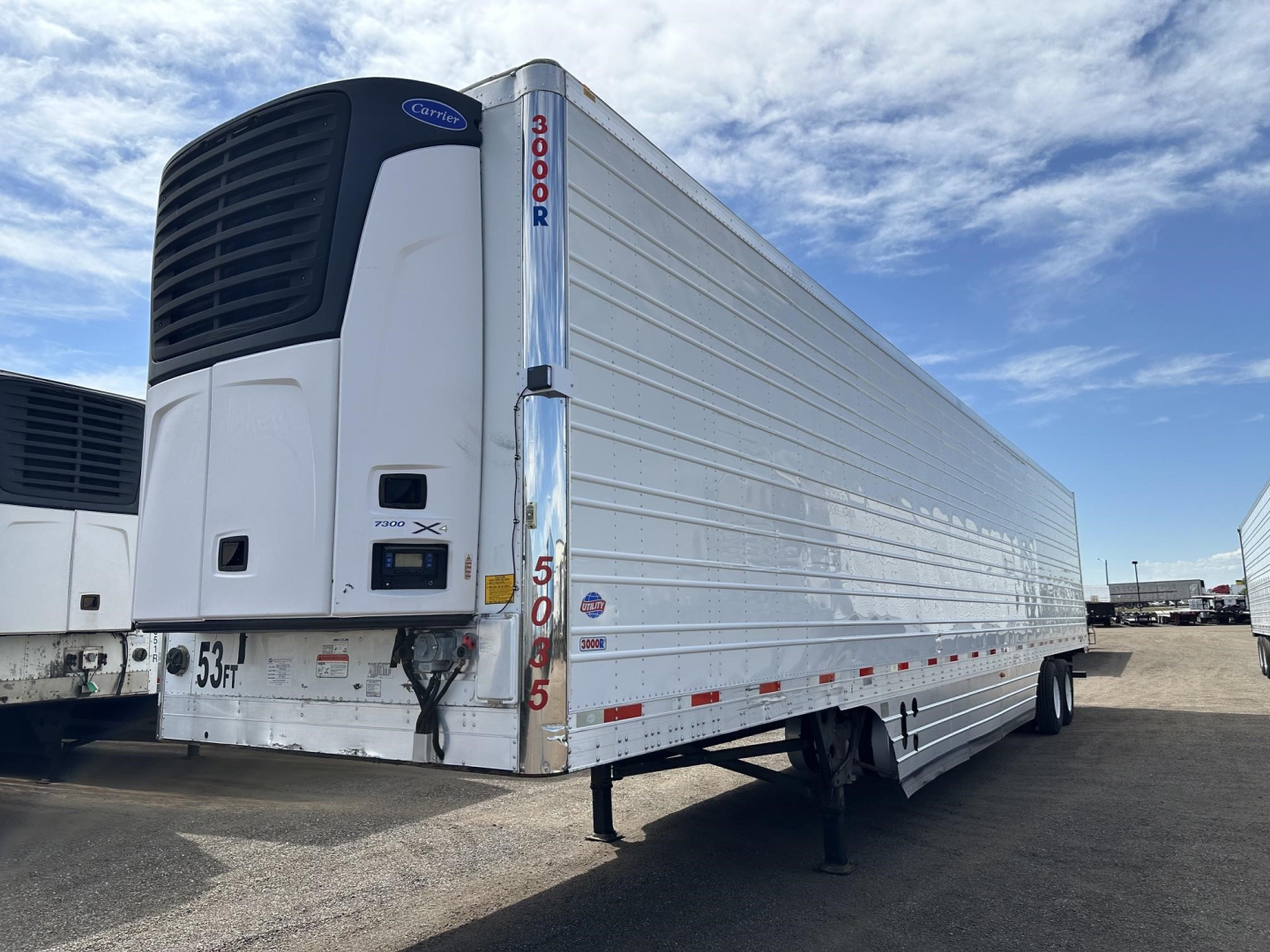 Trailer side view of a 2017 Utility 3000R refrigerated trailer with Carrier refrigeration unit at front, visible VIN/stock numbers on door, and landing gear down.