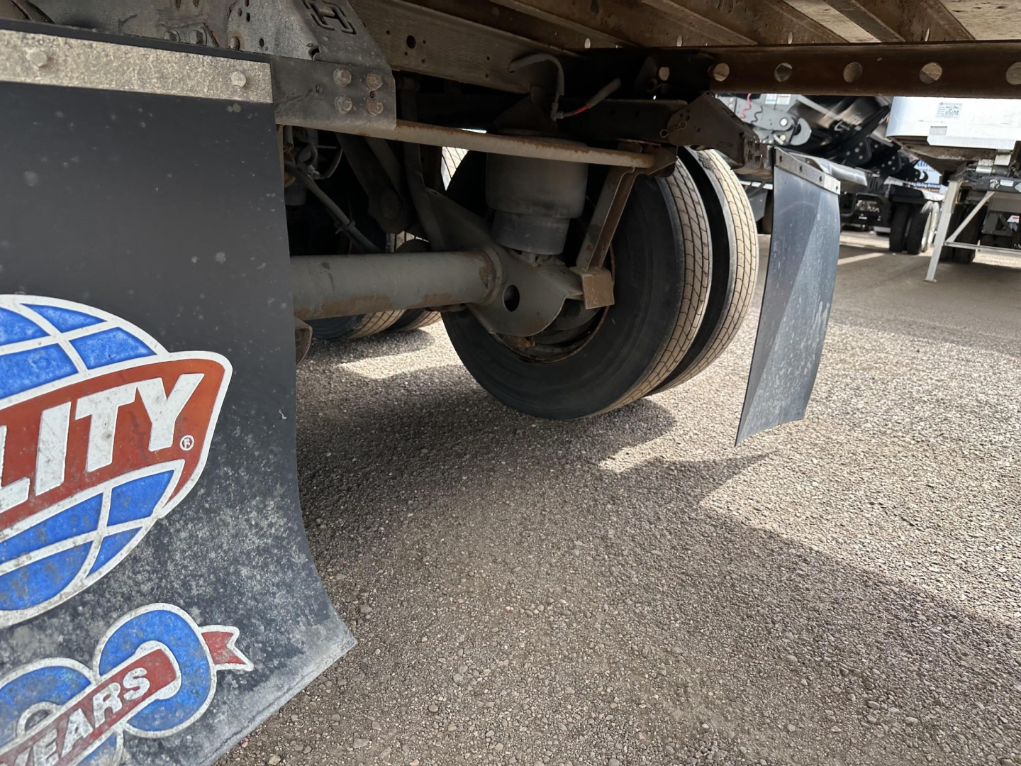 Trailer undercarriage of a 2017 Utility 3000R reefer showing wheel, suspension, and mudflap with partial logo visible.