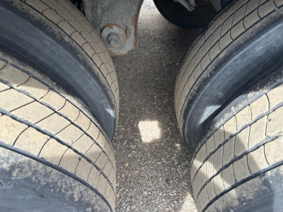 Trailer dual tires and axles from a Utility 3000R showing tread detail and wheel area.