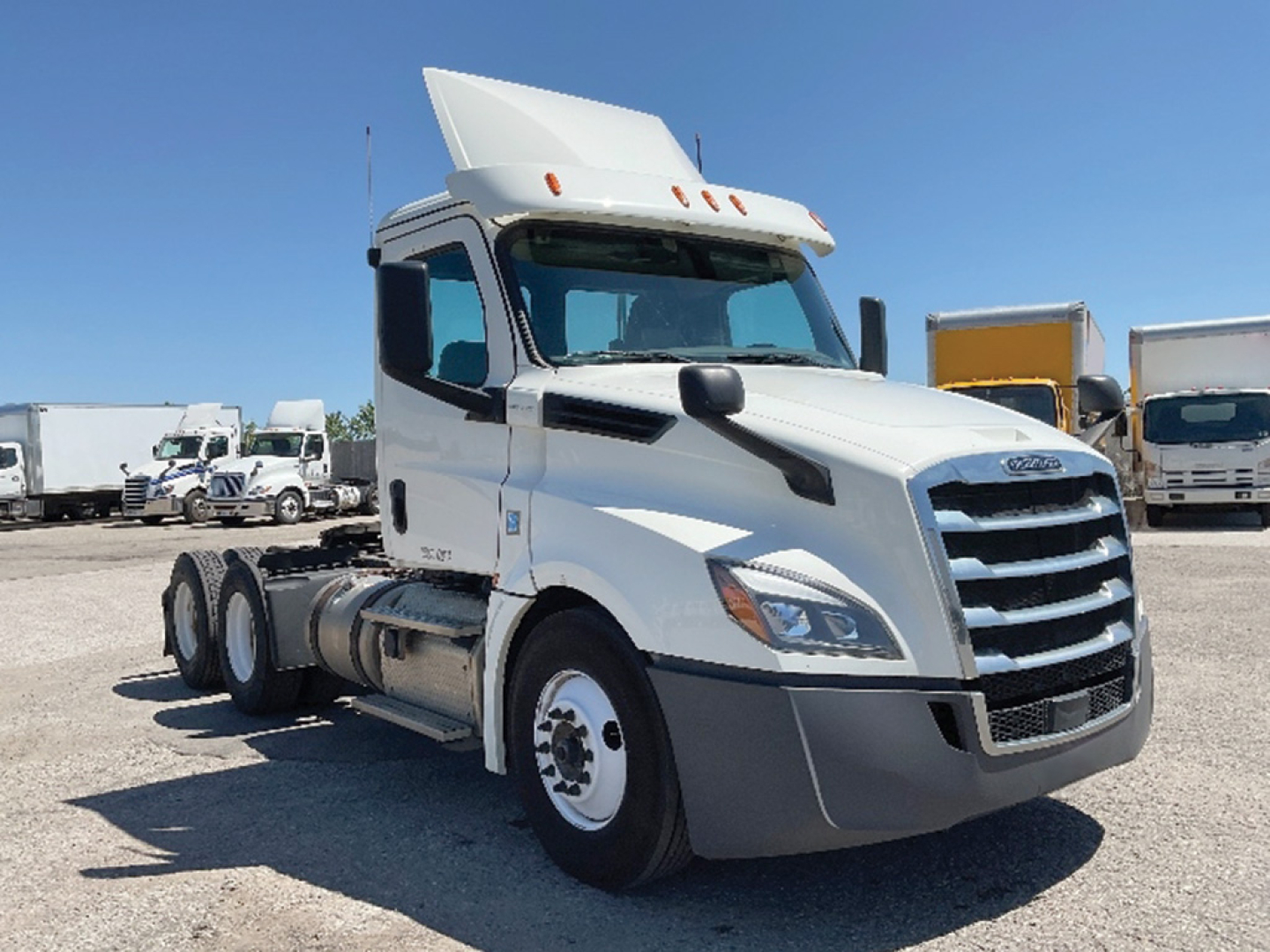 Freightliner Cascadia126 sleeper cab truck in white, side view showing front grille, hood, and cab with raised sleeper top.