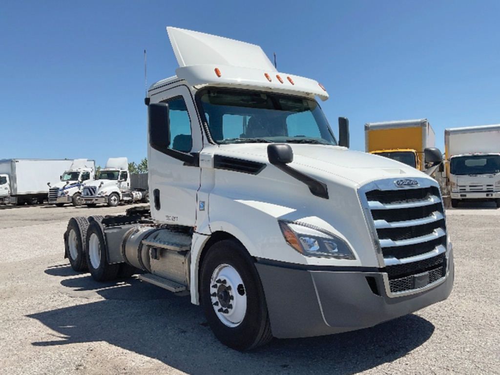 Freightliner Cascadia126 sleeper cab truck in white, side view showing front grille, hood, and cab with raised sleeper top.