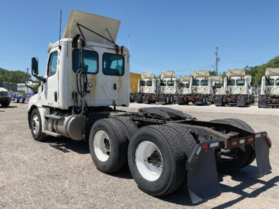 Truck cab and chassis of a 2019 Freightliner Cascadia 126 conventional daycab showing rear dual axles and trailer hitch area.