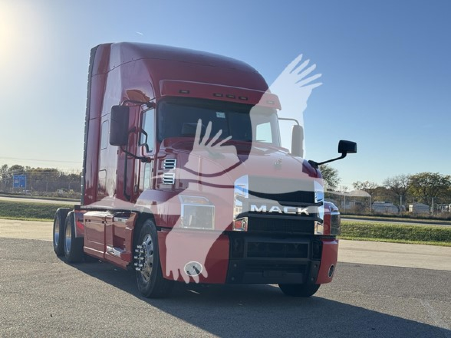 Mack Anthem 64T truck front-left view showing cab, grille with Mack logo, headlights, and side mirrors.