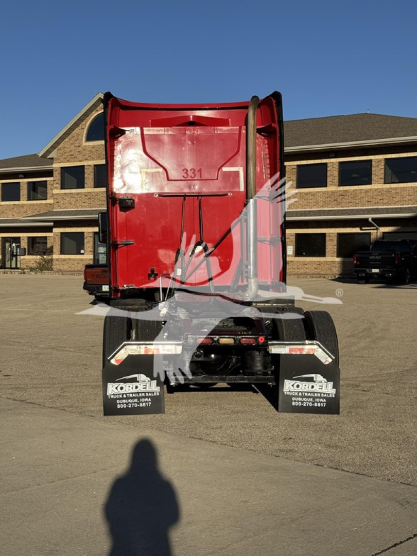 Rear view of a red 2019 Mack Anthem 64T truck, showing the back of the sleeper cab and dual rear axles with mudflaps and bumper area.