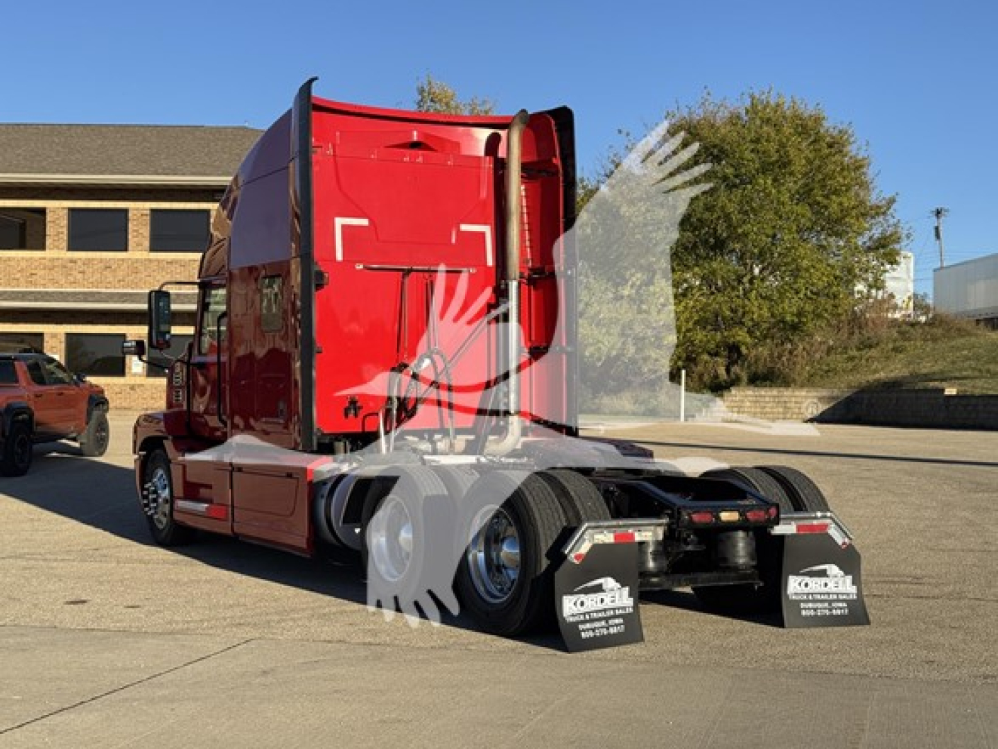 Tractor-trailer cab in red 2019 Mack Anthem 64T with sleeper. Side view shows rear axle and mud flaps, VIN tag and stock number visible.