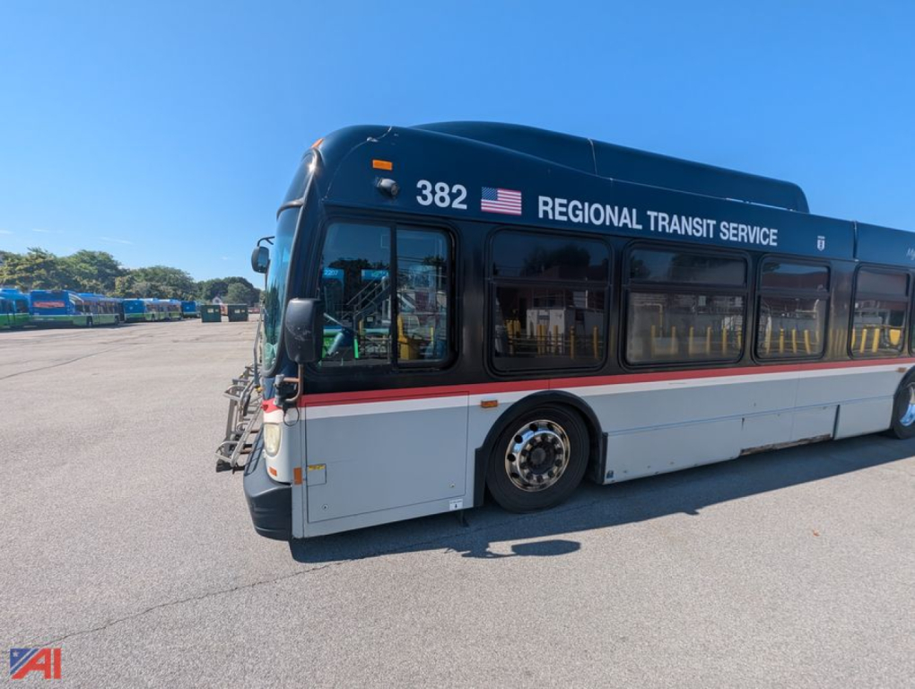 Bus side view showing XD60 transit bus with Regional Transit Service branding, number 382, in-service livery, on a paved lot.
