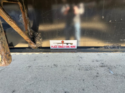 Trailer body showing sticker that reads 'PLACE SINGLE COIL HERE' near bottom edge.