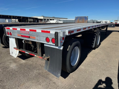 Trailer frame showing rear section of a Fontaine Infinity 48' combo flatbed with dual rear axles, red reflective tape, taillights, and mud flaps.
