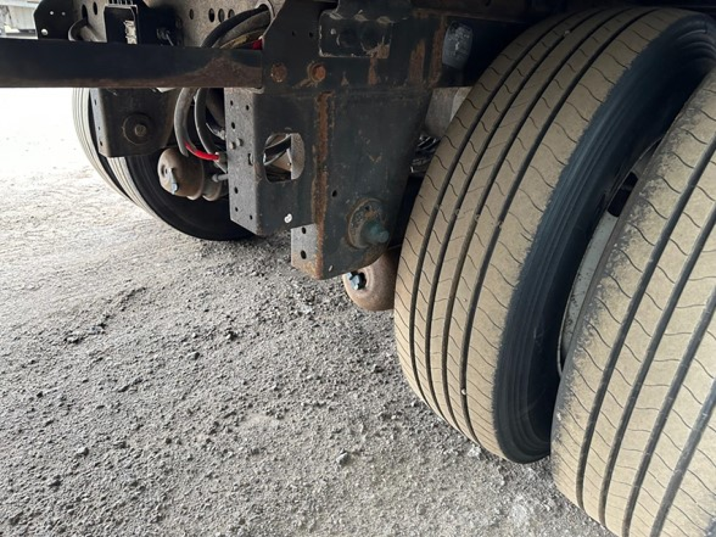 Trailer axle and dual tires view showing rear suspension and frame undercarriage of a 2018 Utility 4000Dx trailer.