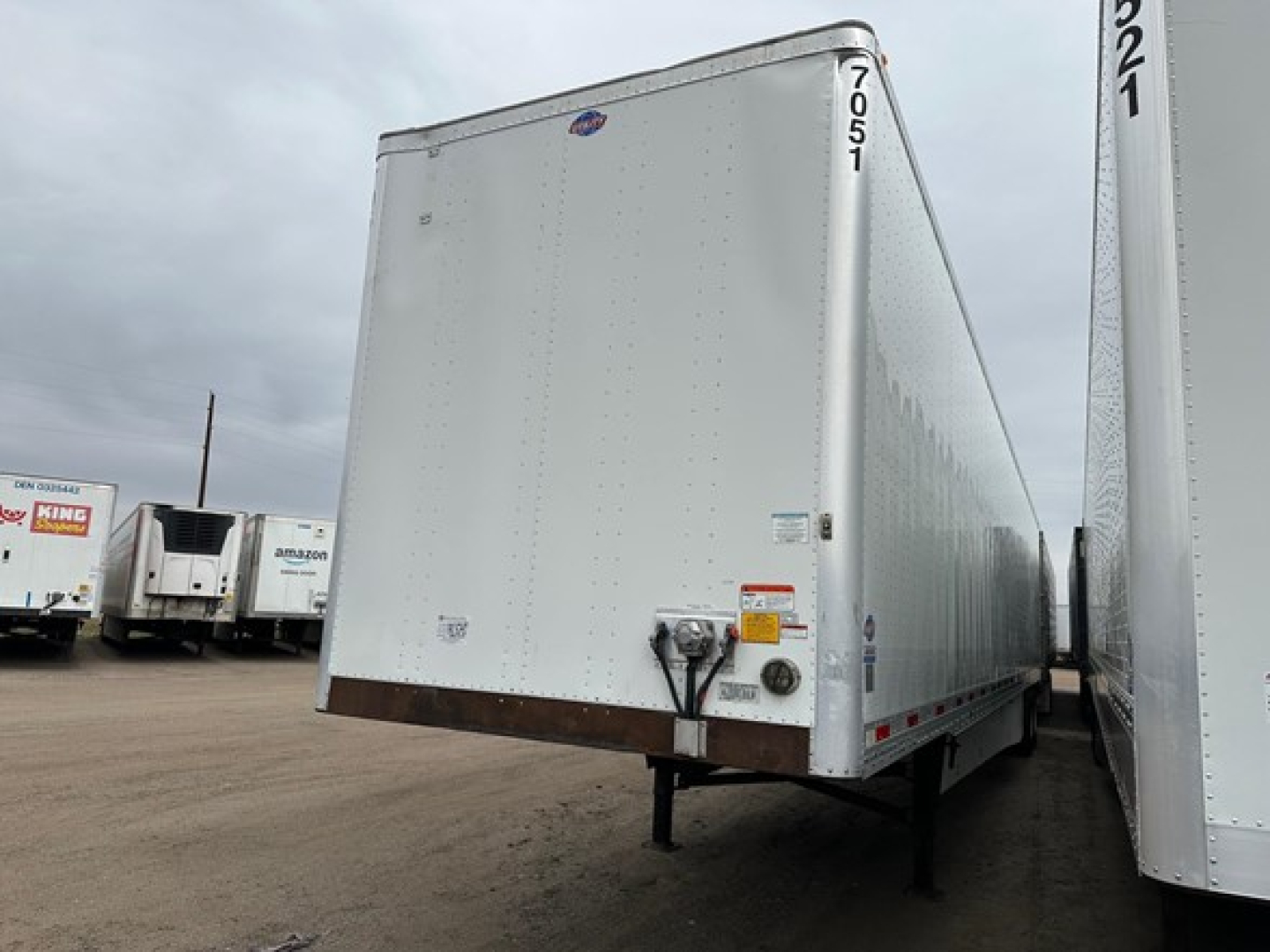 Trailer rear view of a 2018 Utility 4000Dx van trailer showing dual rear doors, reflective tape, and support legs.