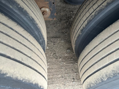 Dual tire view on trailer axle showing tread and sidewall details.