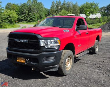 Red 2020 Ram 2500 Tradesman pickup truck with plow in a rural lot.
