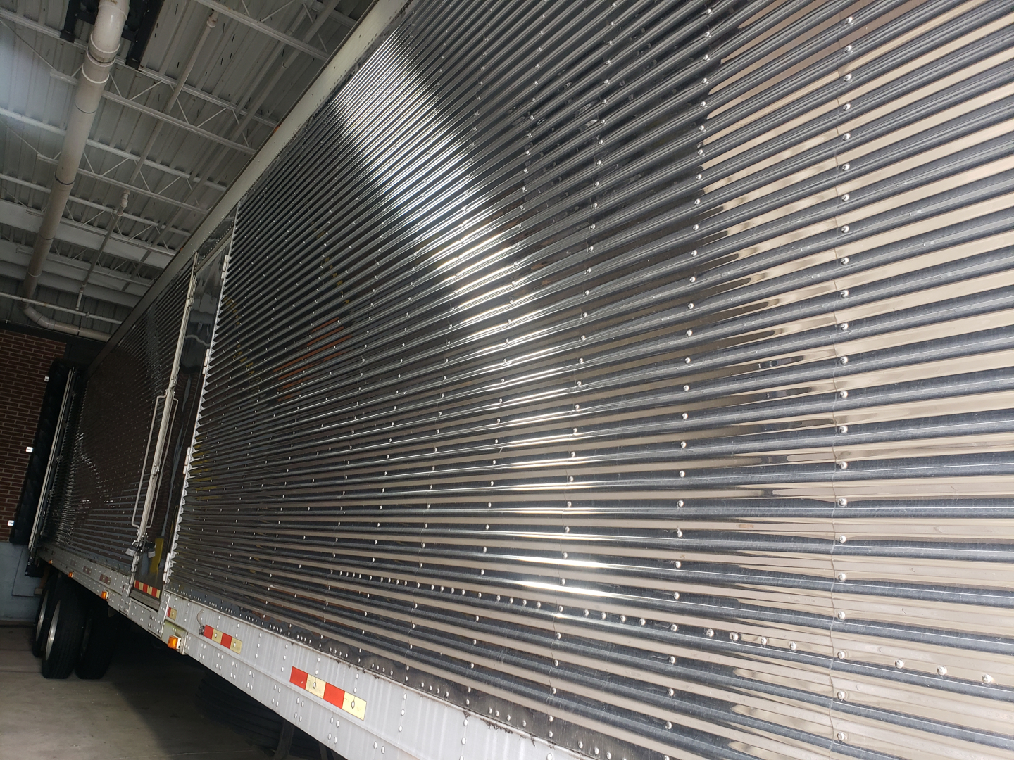Great Dane 53' dry van trailer side view showing ribbed aluminum exterior and tandem axles at rear.