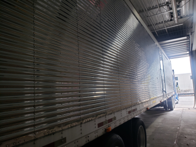 Great Dane 53' dry van trailer side view with ribbed aluminum exterior and tandem axles.