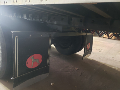 Great Dane 53' dry van trailer undercarriage with legs, rear mudflap, and wheel visible; logo sticker on black mudflaps.