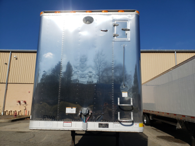 Great Dane 53' dry van trailer back view showing rear doors and bumper with reflective tape and electrical connections.