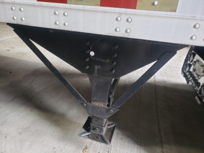Great Dane 53' dry van trailer landing gear and undercarriage seen from front, with jack legs and support frame.