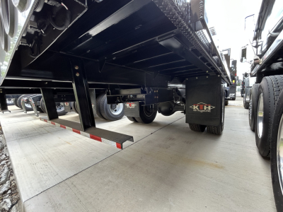MD6 Mack truck undercarriage showing flatbed with black frame and support beams, wheel assemblies, and K&N logo mudflap.