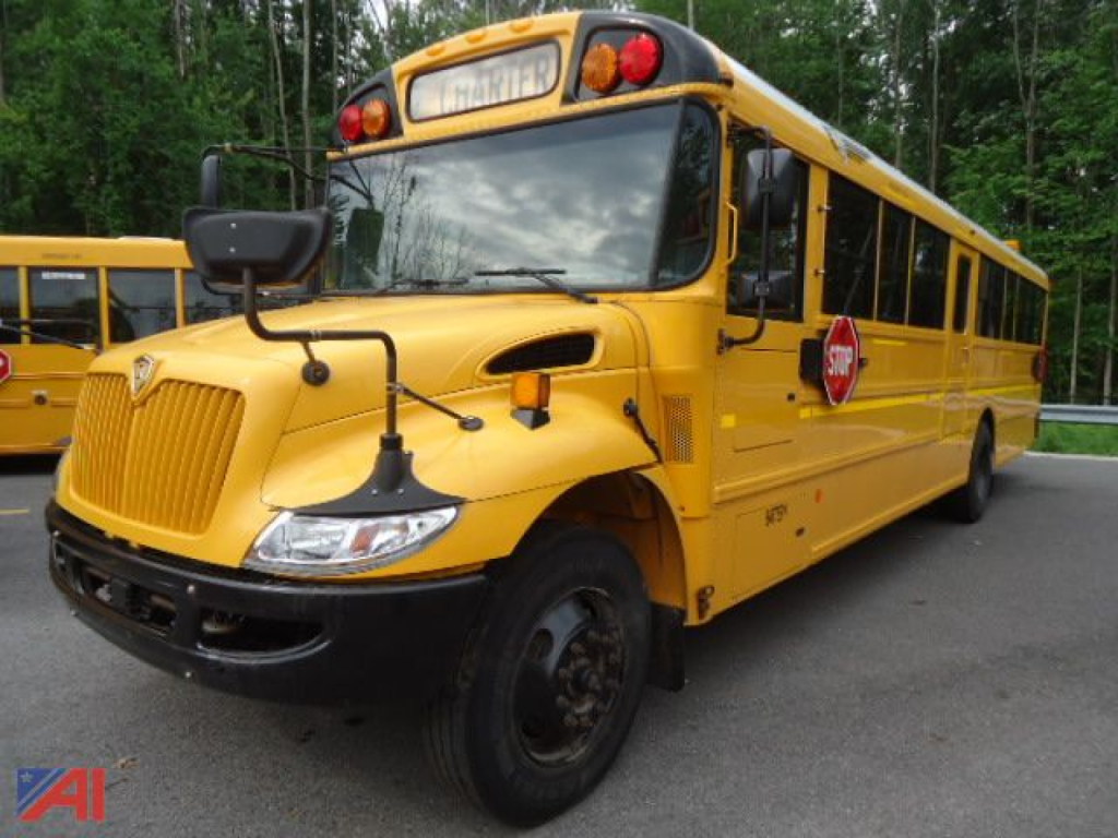 IC Corporation 2011 CE Series school bus in yellow, front-left view with stop sign deployed.