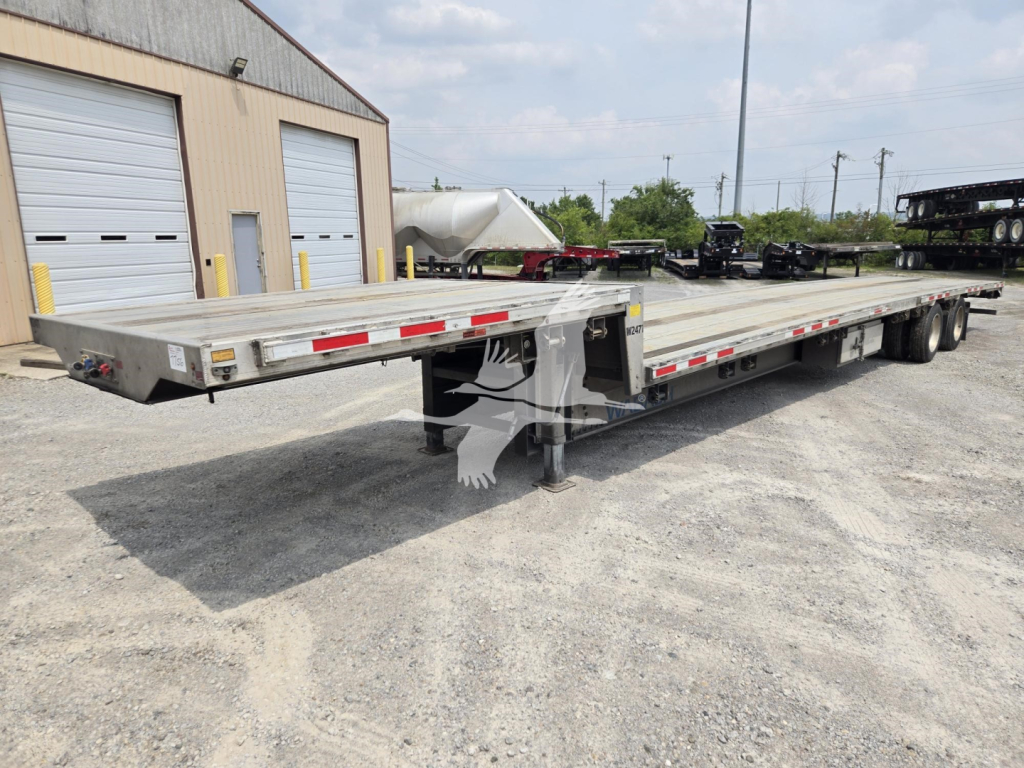 Trailer: 2024 Wabash drop deck trailer showing long flatbed with dual rear axles and center deck support; VIN 1JJG532AXRC446571 stock 7756.