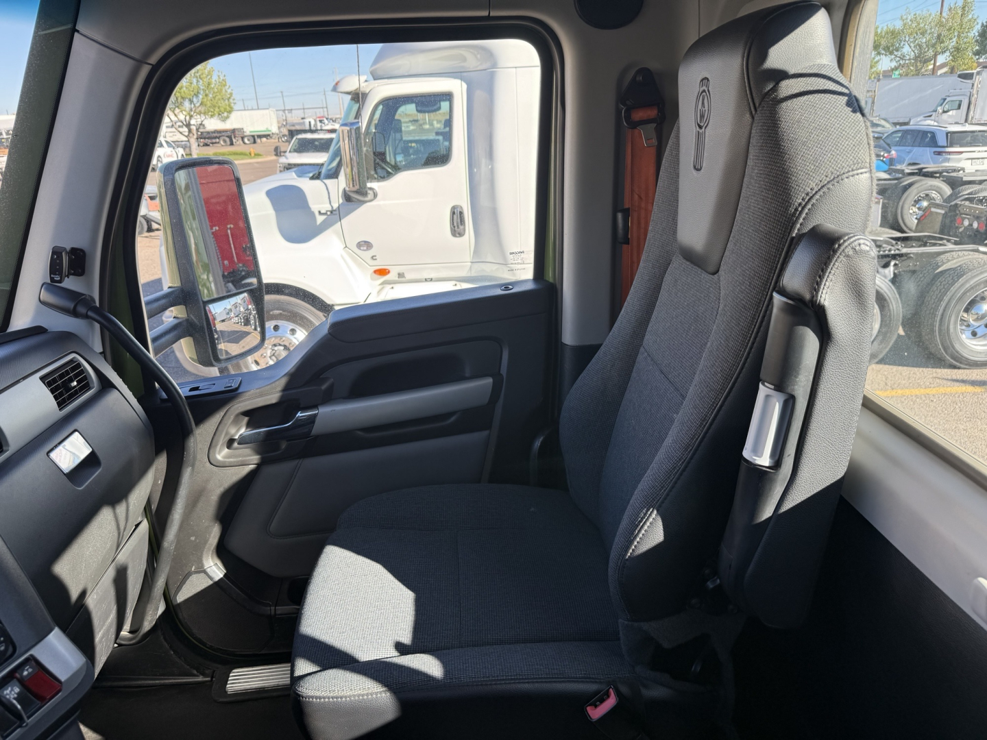 Kenworth T680 interior driver's seat and dashboard view from cab with large window