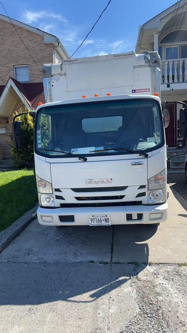Isuzu NRR box truck front view showing cab and box in daylight.