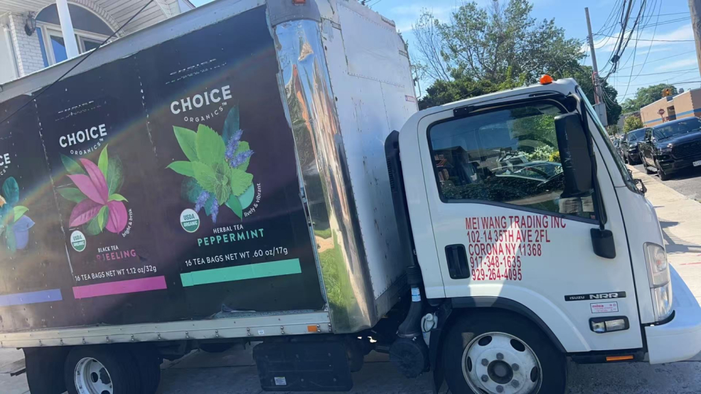 Isuzu NRR box truck side cab with white color and printed company info, black box trailer with Choice logo ads.