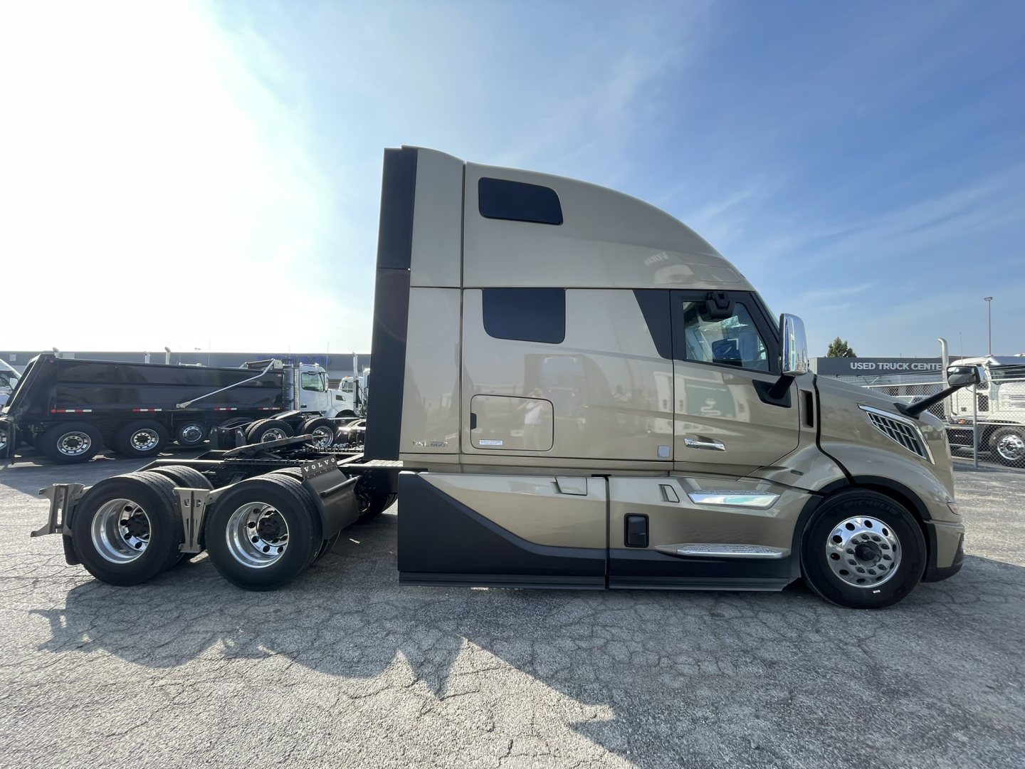 Volvo VNL64T860 tractor-trailer cab side view showing sleeper with windows and dual rear axles.