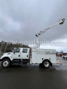 Bucket truck with boom lift in extended position on white International 7400 truck. Side utility compartments visible.