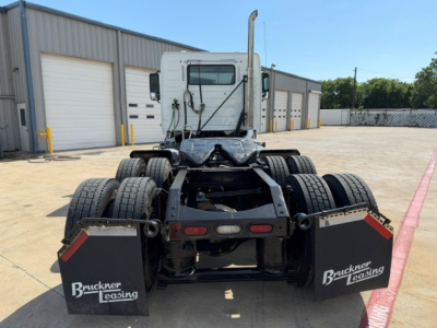 Volvo VNR truck 2018 rear view showing dual rear axle with mud flaps bearing Bruckner Leasing, exhaust stack, and fifth wheel mounting.
