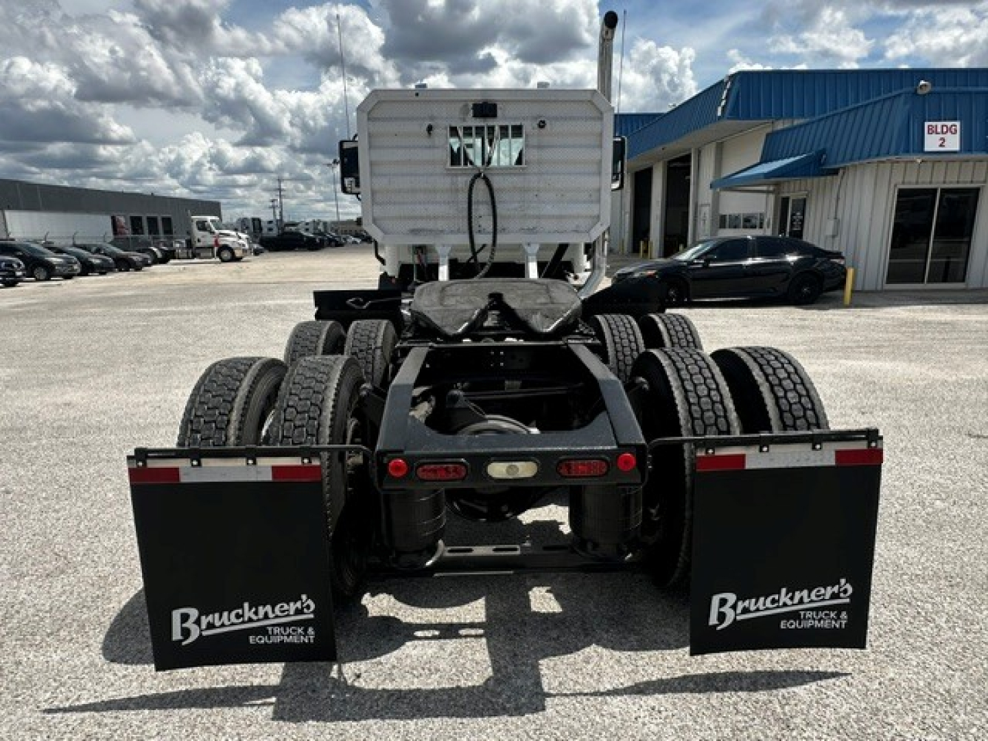Rear view of a 2019 Mack Anthem conventional daycab tractor chassis showing dual rear axles, mud flaps with Bruckner's branding, and fifth wheel area.
