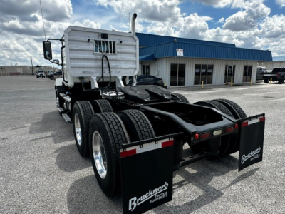 Truck chassis rear view with dual trailer axles and Brackner's logo mud flaps. Sleeper cab visible. 2019 Mack Anthem listing not visible text present.